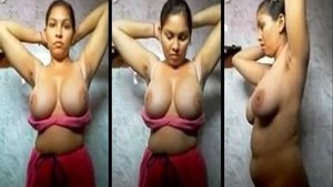 Desi girl flaunts her huge natural tits in a bathroom striptease