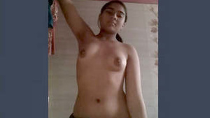 A young Indian college student flaunts her breasts on camera