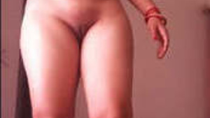 Naked Desi woman standing with her legs spread