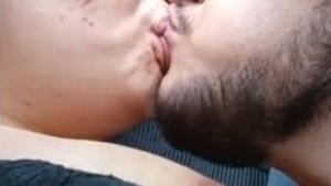 Indian couple kissing passionately in bed