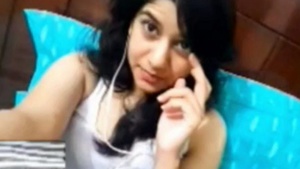 A beautiful girl indulges in breast play with her boyfriend over video call